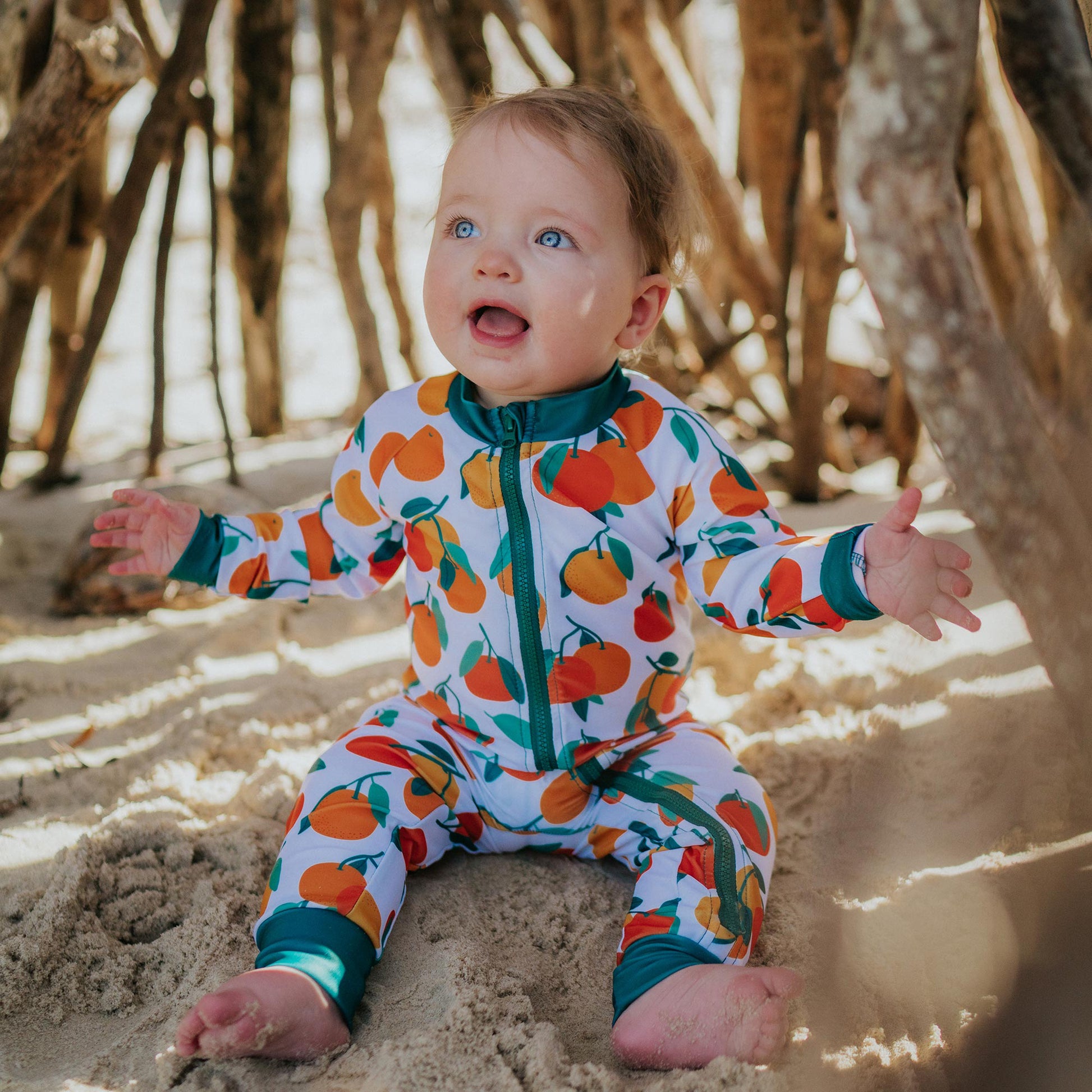 Baby wearing Pipi Swimwear mandarin fruits full length sunsuit