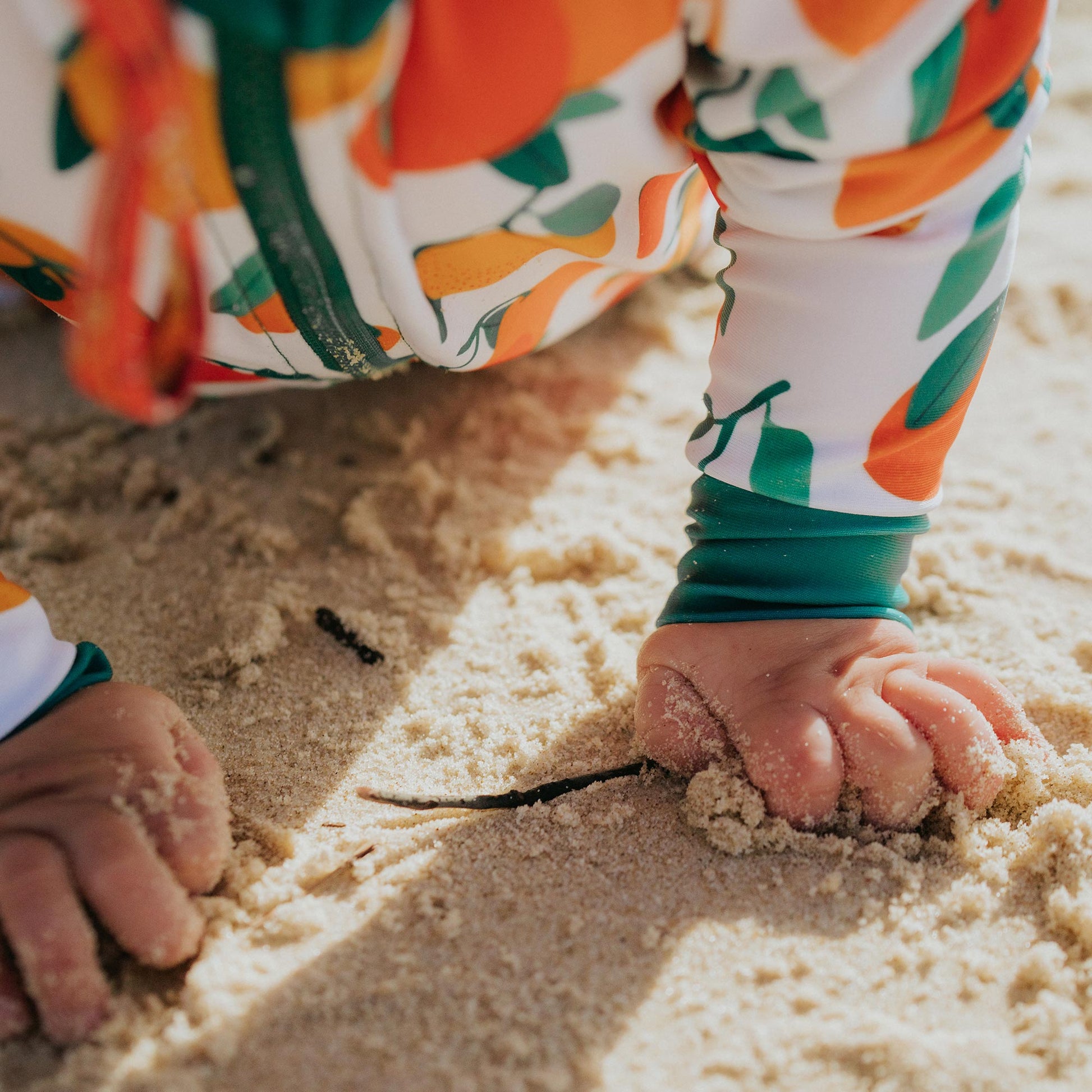 Close up of wrist cuff of mandarin fruits full length sunsuit