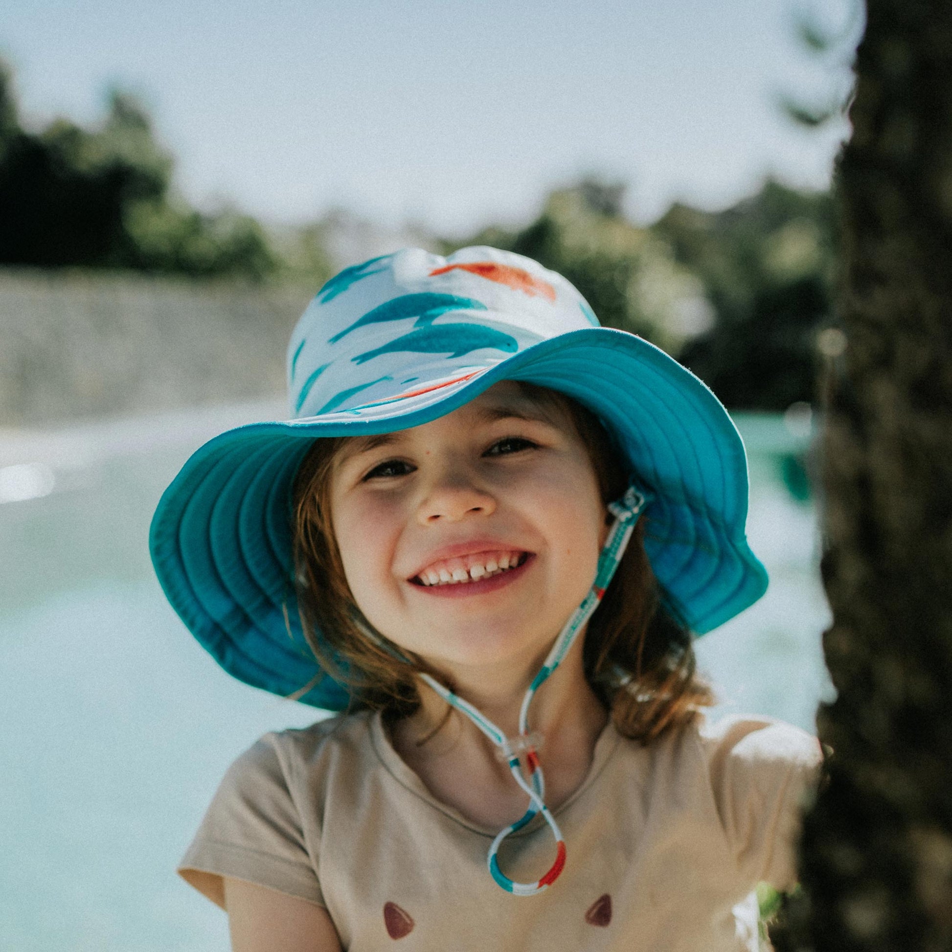 Child wearing Pipi Swimwear narwhal reversible wide brim swim hat