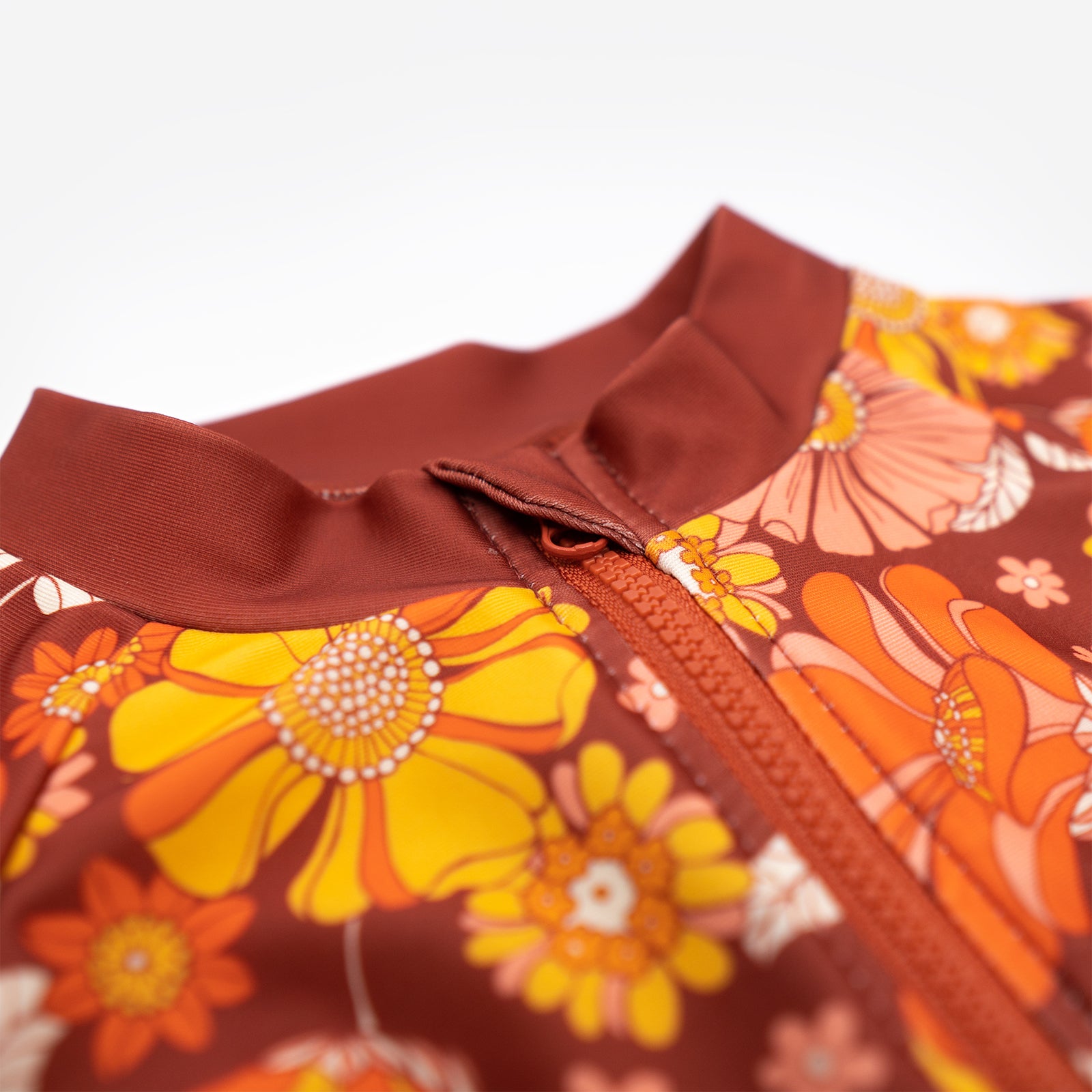 Close up of neckline of Pipi Swimwear Good Vibes floral full length sunsuit